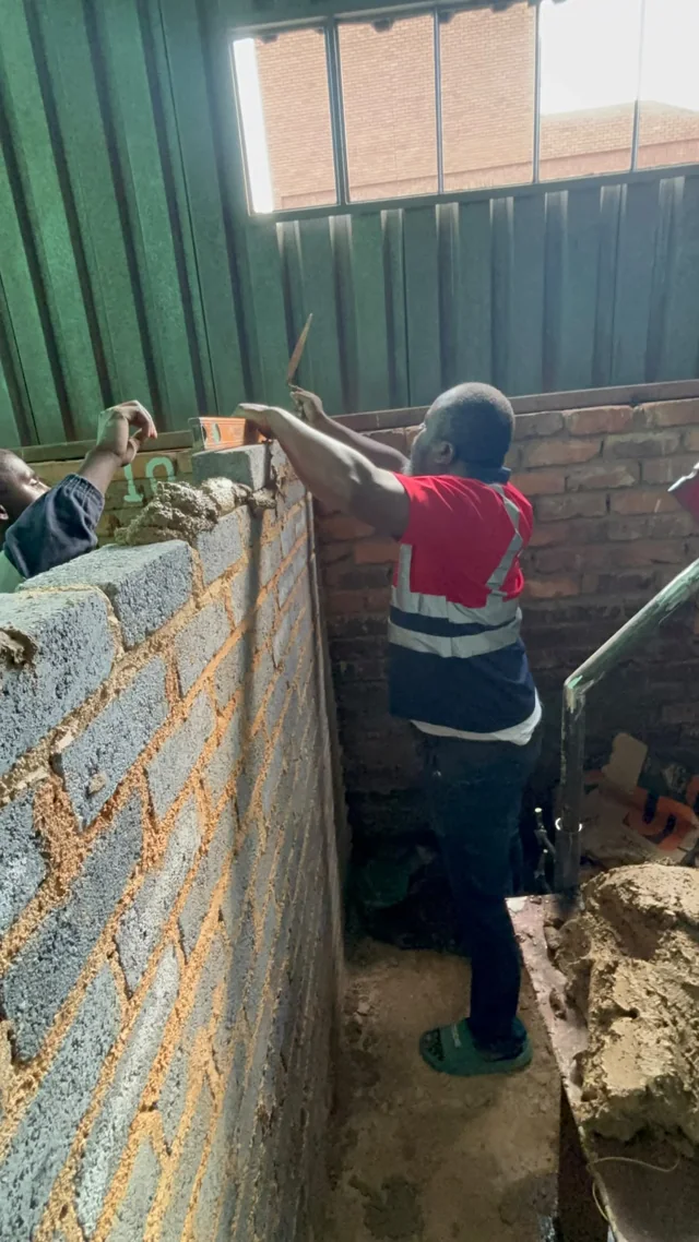 Participant working along the top of a training wall
