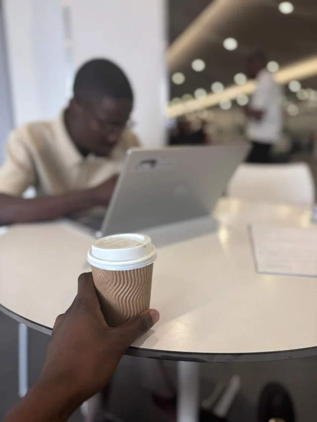 Participant working at a laptop during a group session