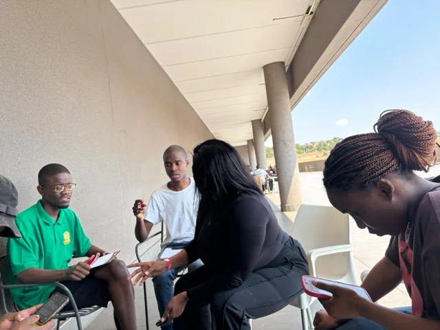 AIET IT group discussing ideas together