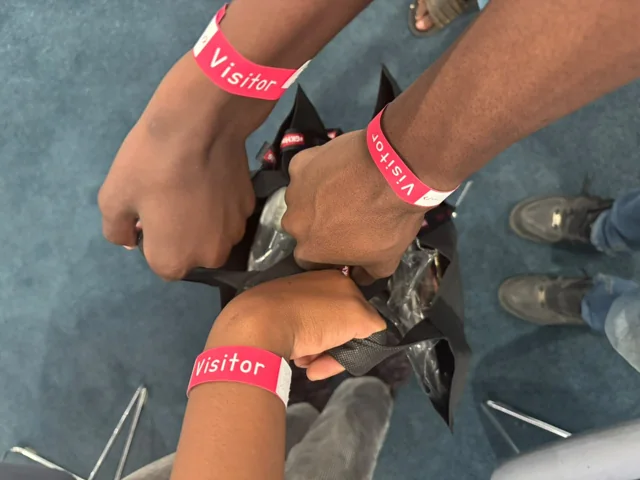 Participants bringing their event wristbands together