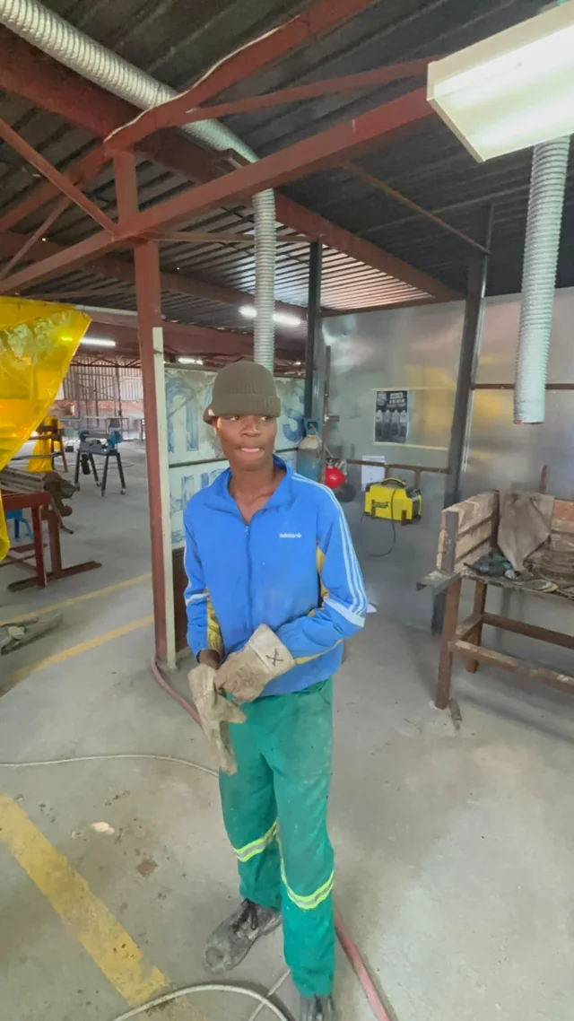 Participant standing in the plumbing and building workshop