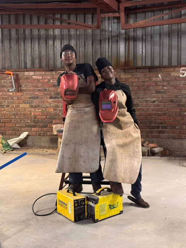 Boilermaking students sharing a light-hearted workshop moment